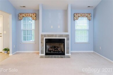 Cozy gas fireplace flanked by windows