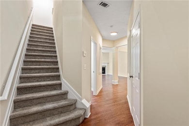 Staircase with visible vents, baseboards, wood fin