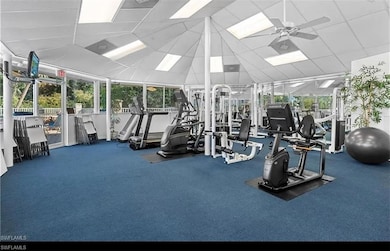 Exercise room with carpet flooring, a paneled ceil