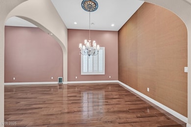 Formal Dining Room framed by dramatic archways tha