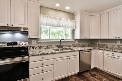 Kitchen includes stainless steel appliances and recessed lighting