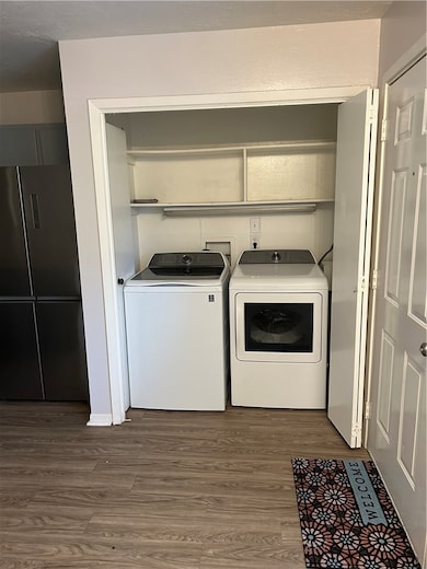 Laundry room featuring washing machine and clothes