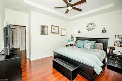 Master bedroom with tray ceiling and upgraded floo