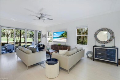 Living room featuring ceiling fan, plenty of natur