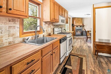 Kitchen featuring sink, dark hardwood / wood-style