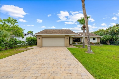 View of front of home with decorative driveway, a