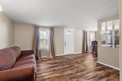 Living room with dark hardwood / wood-style flooring