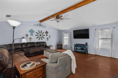 Living room with lofted ceiling with beams, ceilin