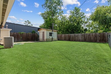 Spacious backyard with a well-maintained lawn, sto