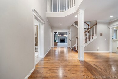 Step inside the open foyer onto hardwood floors. T