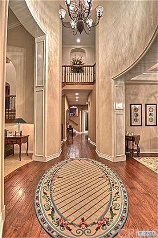 25' Foyer with extensive custom wood accents frame