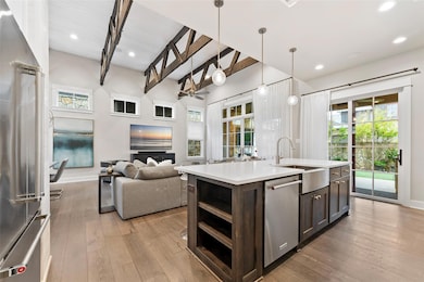 Kitchen featuring light wood finished floors, lig