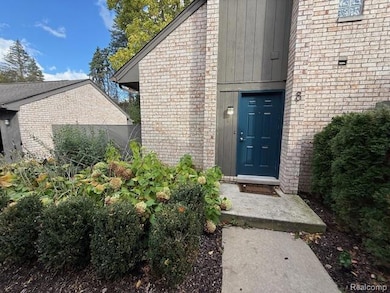 Doorway to property with board and batten siding and brick siding