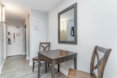 Dining room featuring baseboards and light wood fi