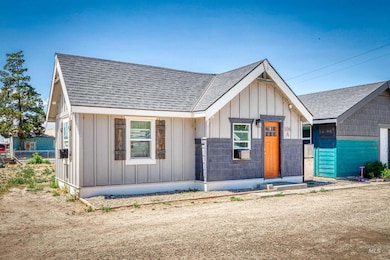 View of front of property featuring board and batten siding and roof with shingles