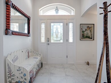 An arched window and glass inserts on the entry do