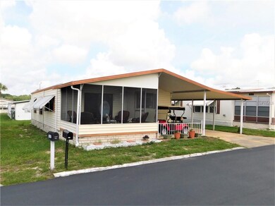 Front of home has covered sitting area or golf car