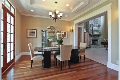 Dining Room with hardwood flooring, mouldings and recessed lighting
