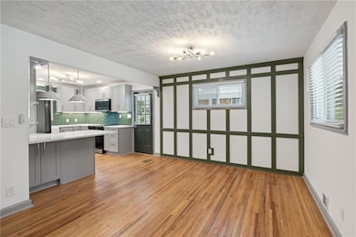 Kitchen featuring backsplash, light wood-style flo