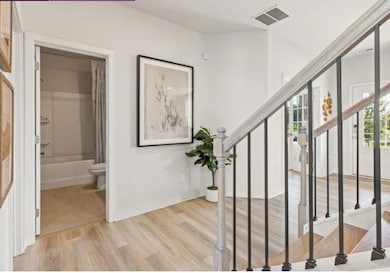 Stairway featuring wood finished floors