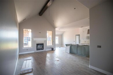 Unfurnished living room with beam ceiling, wood finished floors, a glass covered fireplace, and high vaulted ceiling