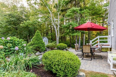 Well landscaped with patio and fire pit.
