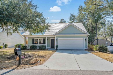 View of front of house featuring a garage and a po