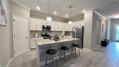 Kitchen featuring light stone counters, a kitchen 