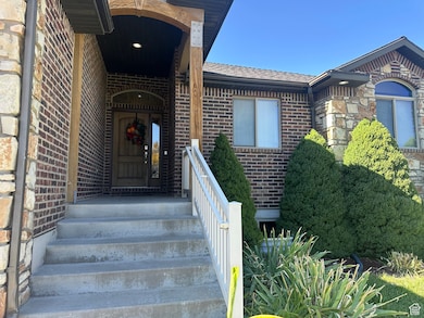 Property entrance with brick siding and roof with shingles