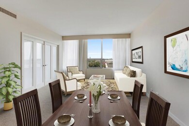 Large living/dining room with views of the city.