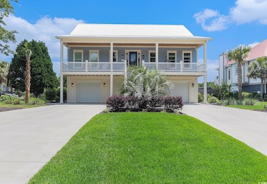 Beach home with driveway, an attached garage, and a front yard