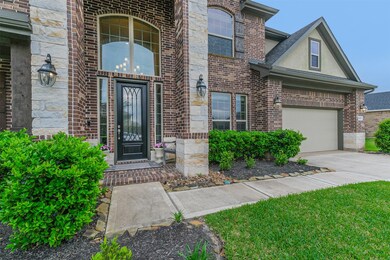 Back to the front of the home - you will notice the stunning updated door, stone and brick accents, and three car tandem garage with plenty of driveway parking.