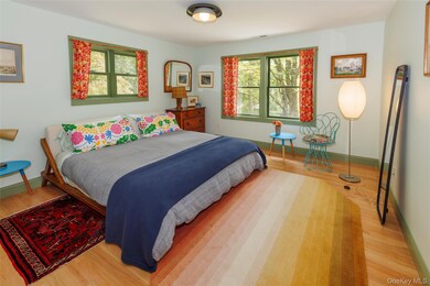 Bedroom with light wood-type flooring and baseboards