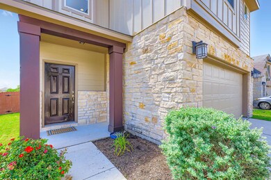 Property entrance with stone siding, board and ba