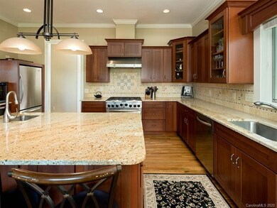Tumbled tile designer back splash with under counter lighting complete the flawless kitchen.