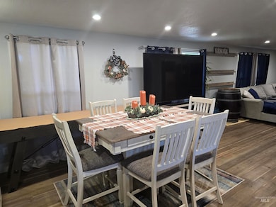 Dining area featuring dark wood-style flooring and recessed lighting