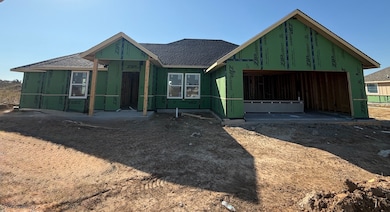 Property in mid-construction with roof with shingles
