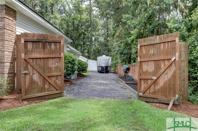 This gate with privacy fence leads to a long RV/bo