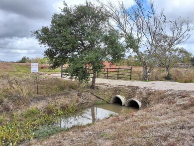 View showing entry driveway over concrete culverts