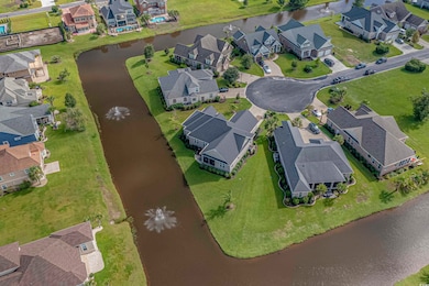 Aerial view of property's location featuring nearby suburban area and a large body of water