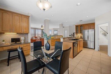 Kitchen featuring stainless steel refrigerator, di