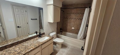 Bathroom with vanity, shower / bath combo with sho