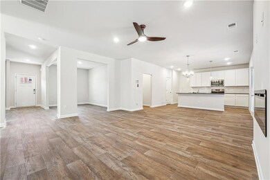 Unfurnished living room with visible vents, recess