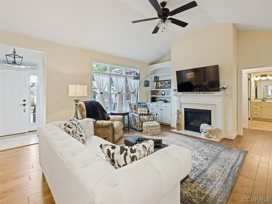 FAMILY ROOM VIEW LOOKING INTO FOYER AREA AND VIEW INTO PRIVATE WING PRIMARY BEDROOM AND BATH SPACE.