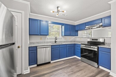 Kitchen featuring ornamental molding, sink, exhaus