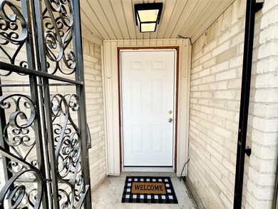 A decorative freshly painted wrought iron gate wel
