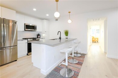Kitchen with stainless steel appliances, light wo