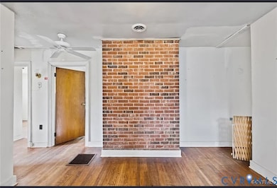 Unfurnished room with wood finished floors and ceiling fan