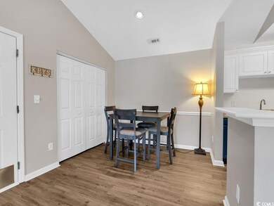 Dining space with sink, lofted ceiling, and light 