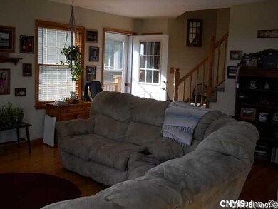 Living Room. Living Room with Open Staircase to Lo